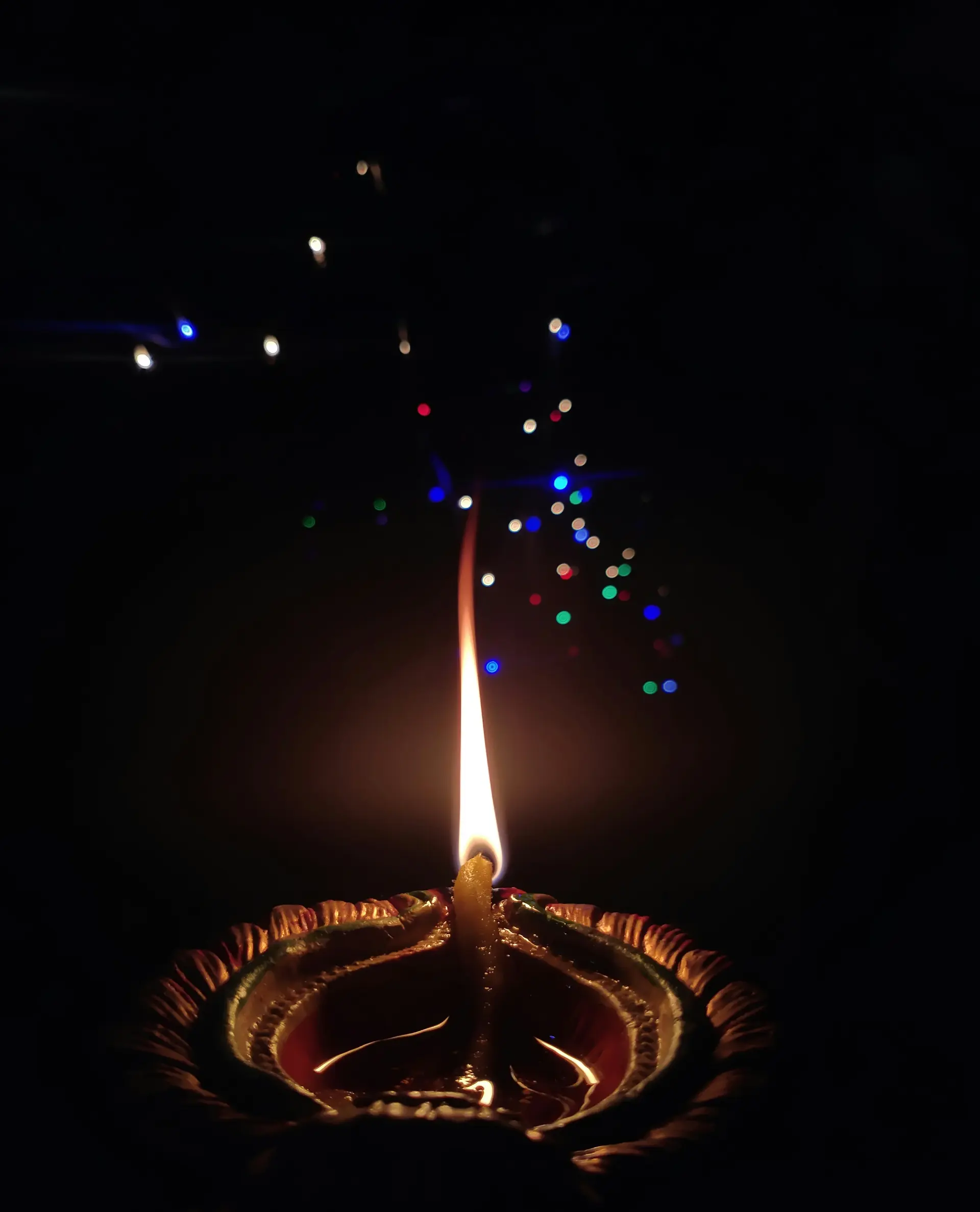 Single diya with warm bokeh